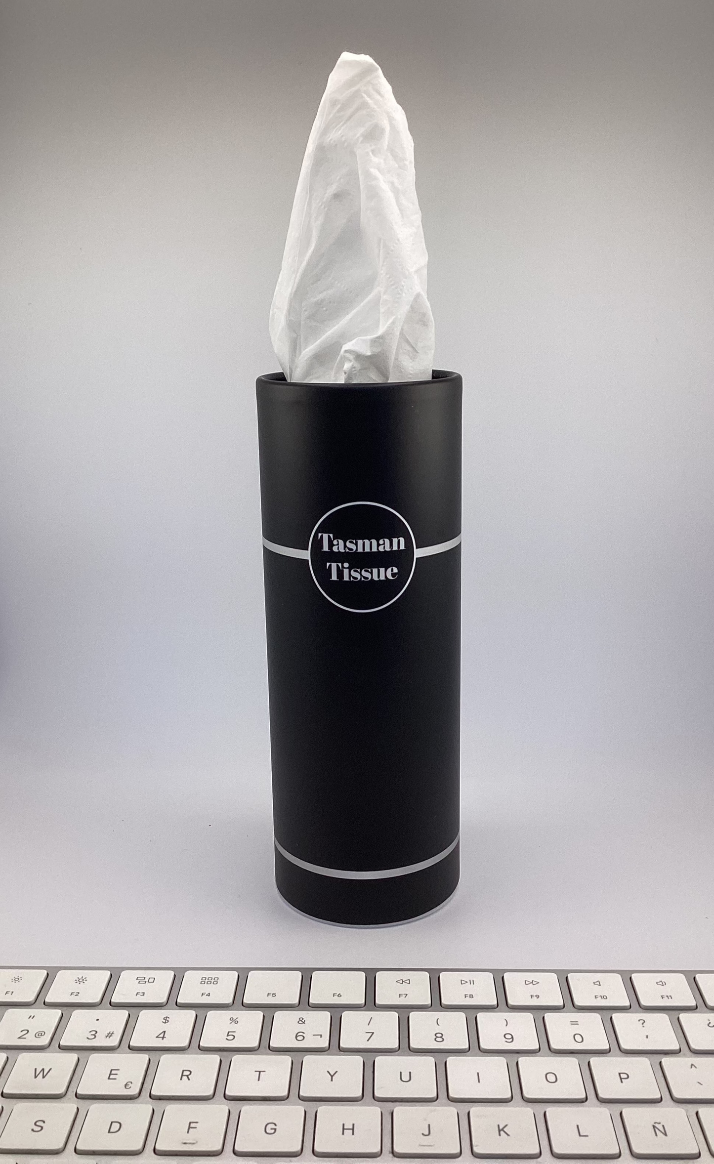 Paper tissue in black silver cylindrical container for desk and car